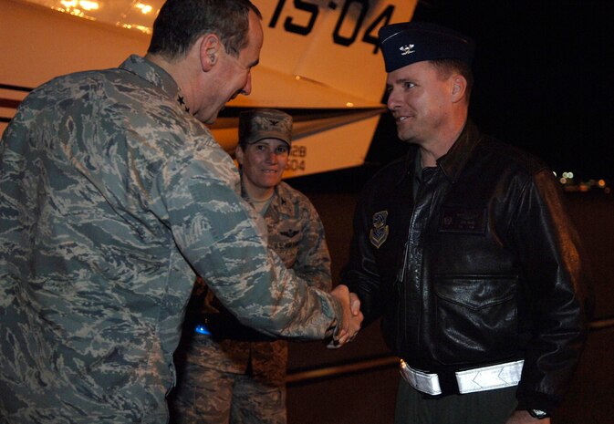 Gen. Raymond Johns is greeted by Col. John Wood after his evening arrival here Feb. 17. General Johns paid a brief visit to Joint Base Charleston before departing for Haiti to survey the relief efforts for Operation Unified Response. General Johns is the commander of the Air Mobility Command and Colonel Wood is the 437th Airlift Wing commander. (U.S. Air Force photo/Airman 1st Class Lauren Main)