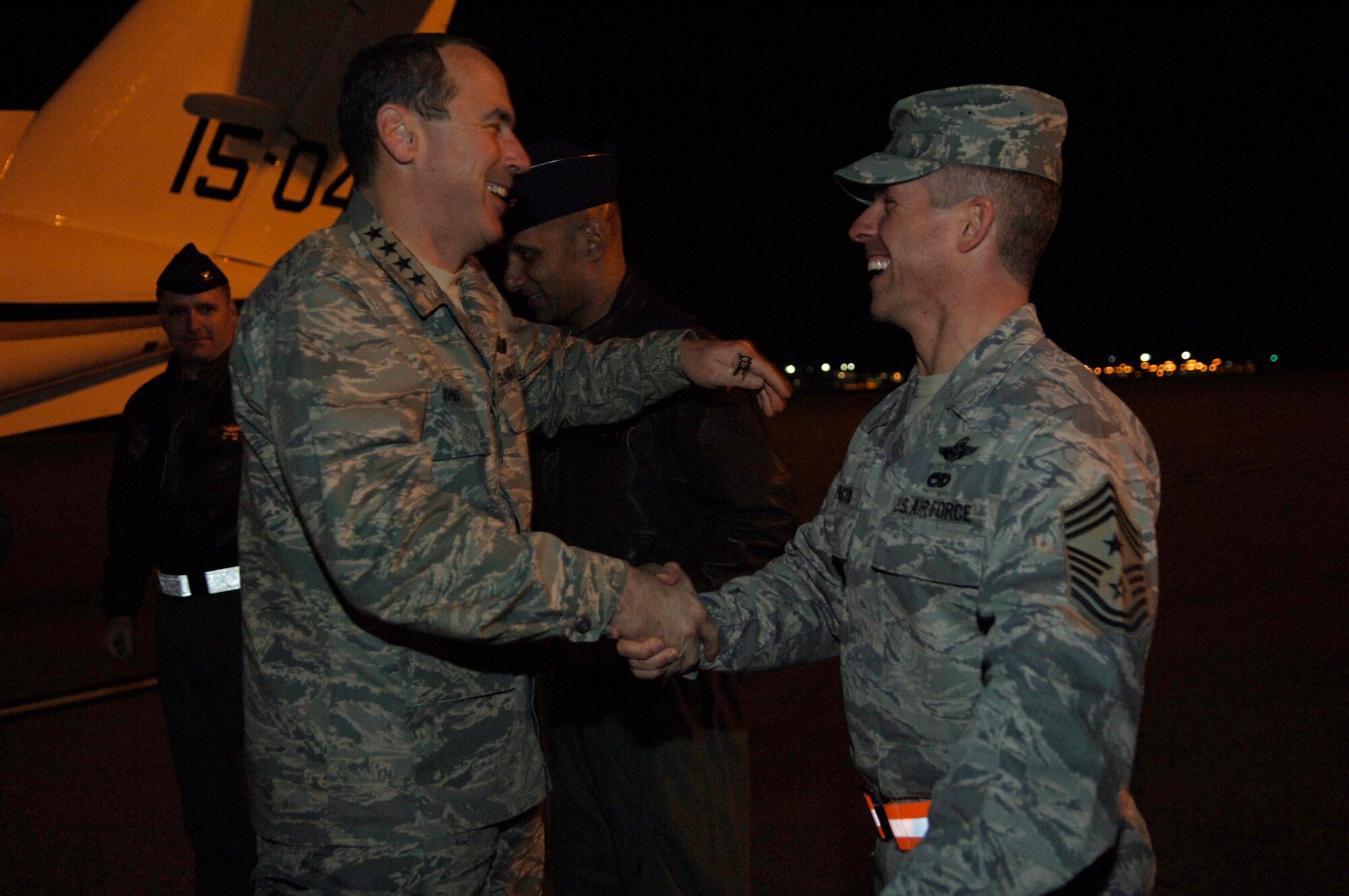 Gen. Raymond Johns is greeted by Chief Master Sgt. David Spector at Joint Base Charleston during a brief base visit on his way to Haiti Feb. 17 . Chief Spector arrived at the base earlier in the week and joined the general for a briefing on Charleston's Haiti stage operations. General Johns is the commander of Air Mobility Command and Chief Spector is the AMC command chief. (U.S. Air Force photo/Airman 1st Class Lauren Main)