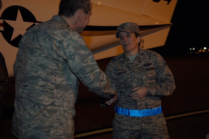 Gen. Raymond Johns steps down from his plane to be greeted by Col. Martha Meeker here Feb. 17. General Johns paid a brief visit to Joint Base Charleston before departing for Haiti to survey the relief efforts for Operation Unified Response. General Johns is the commander of Air Mobility Command and Colonel Meeker is the 628th Air Base Wing commander. (U.S. Air Force photo/Airman 1st Class Lauren Main)