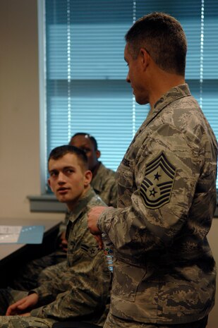 Chief Master Sgt. David Spector speaks with Airman 1st Class Bryan Faircloth during a visit to the First Term Airmen Center here Feb. 17. Chief Spector toured the base visiting with Airmen, giving direction and taking feedback on where Airmen see themselves in the Air Force and where they are headed. Chief Spector is the command chief of Air Mobility Command, and Airman Faircloth is a crew chief with the 437th Aircraft Maintenance Squadron. (U.S. Air Force photo/Airman 1st Class Lauren Main)