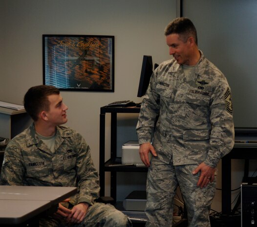 Chief Master Sgt. David Spector speaks with Airman 1st Class Bryan Faircloth during a visit to the First Term Airmen Center here Feb. 17. While touring the base, Chief Spector made numerous scheduled visits to speak with Airmen about being successful and the importance of setting achievable goals for themselves. Chief Spector is the command chief of Air Mobility Command, and Airman Faircloth is a crew chief with the 437th Aircraft Maintenance Squadron. (U.S. Air Force photo/Airman 1st Class Lauren Main)
