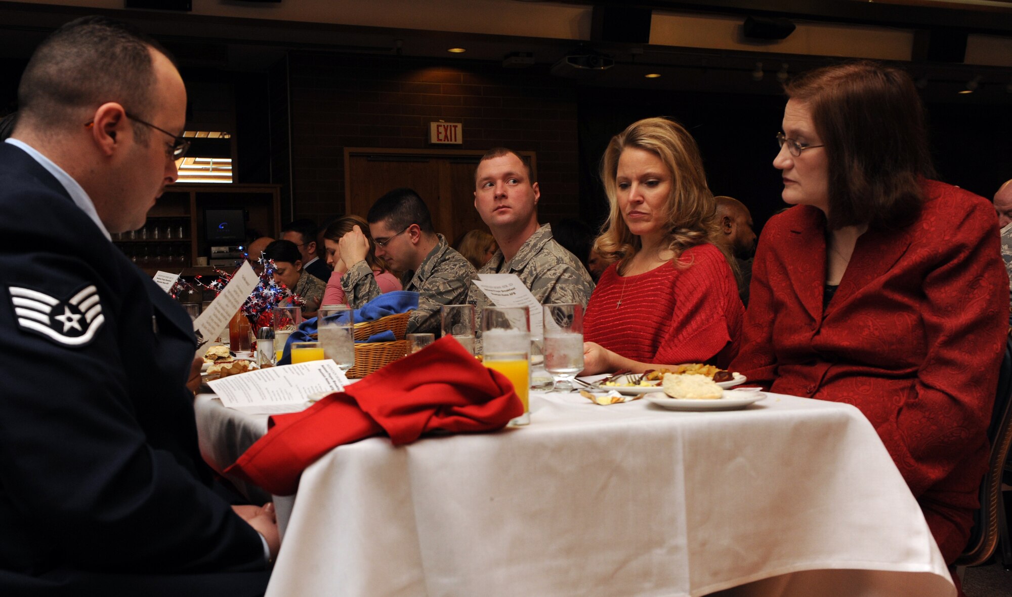 MOUNTAIN HOME AIR FORCE BASE, Idaho -- Attendants of the National Prayer Breakfast follow along to a responsive reading during a ceremony held at the Gunfighter Club Feb. 11. The National Prayer Breakfast is an annual event started by members of the Senate and House prayer groups and President Eisenhower in 1953. (U.S. Air Force photo by Airman 1st Class Debbie Lockhart)
