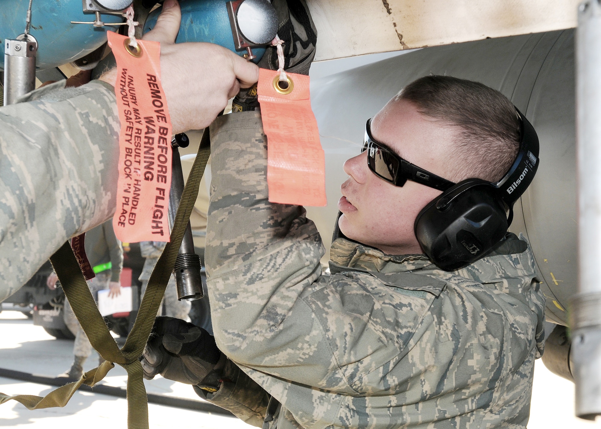 Airman 1st Class Nicholas Stockbridge loads a BDU-33, a small cast-iron and steel non explosive ordnance that is used in training to simulate actual bombs, on to an F-16 Fighting Falcon Feb. 3, 2010, at Zaragoza Air Base, Spain. During their deployment here, approximately 1,132 BDU-33?s were loaded to F-16?s for training operations. Airman Stockbridge is assigned to the 555th Aircraft Maintenance Unit. (U.S. Air Force photo/Senior Airman Tabitha M. Mans)