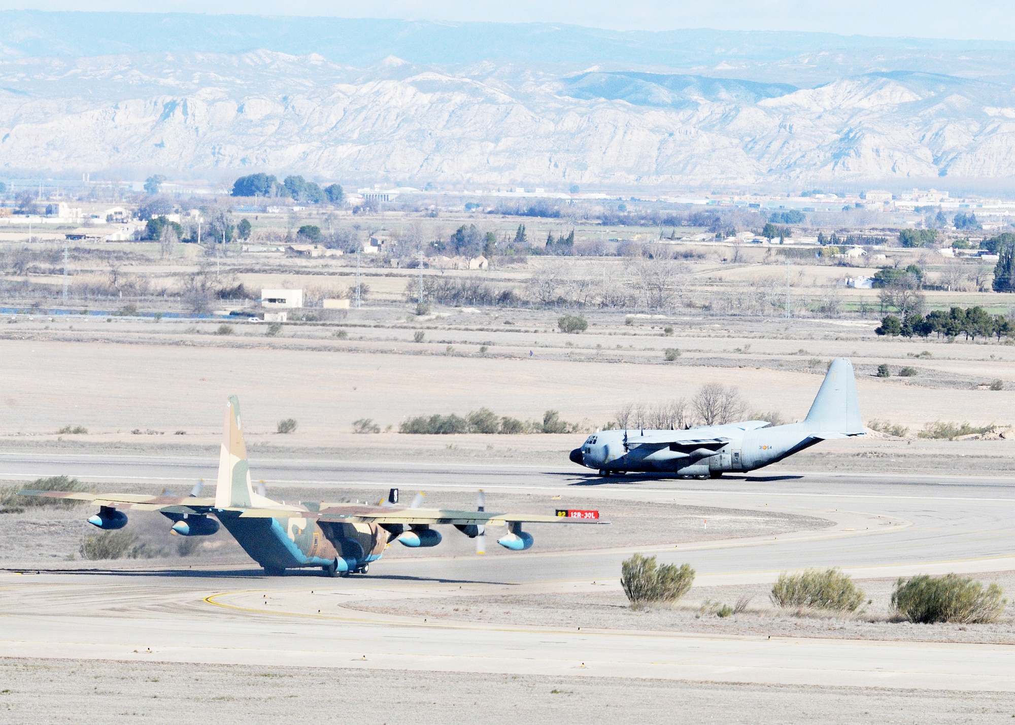 An Air Force C-130 and a Spanish air force C-17 prepare for takeoff Feb. 1, 2010, from Zaragoza Air Base, Spain. U.S. and Spanish air forces shared a runway and airspace during the 555th Fighter Squadron?s 2010 training deployment to Spain. (U.S. Air Force photo/Senior Airman Tabitha M. Mans)