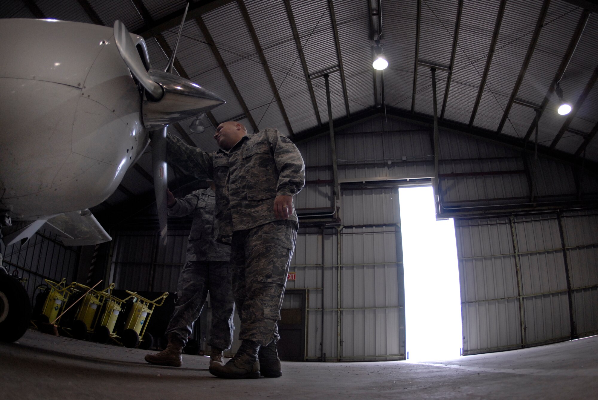 VANDENBERG AIR FORCE BASE, Calif. --Tech. Sgt. Donald Baily, 30th Operations Support Squadron airfield manager, and Staff Sgt. Lilanae Martin, 30th OSS NCO in charge of airfield operations, view the damaged engine block on a 1966 Cessna Skyway airplane here Thursday, Feb. 18, 2010.  The civilian airplane had to make an emergency landing on the flightline due to the damaged engine block here Wednesday, Feb. 17, 2010.    (U.S. Air Force photo/Senior Airman Andrew Satran) 

 
 