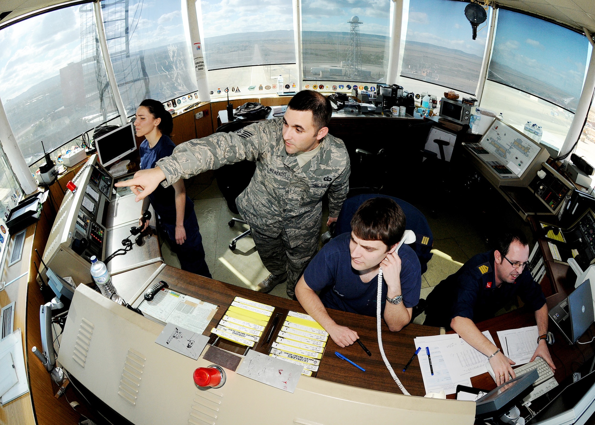 Staff Sgt. Joe Menendez assists Spanish air force air traffic controllers Feb. 1, 2010, at Zaragoza Air Base, Spain. Sergeant Menendez ensures proper communication between the U.S. pilots and Spanish ATCs to maintain safe missions. Sergeant Menendez is an air traffic control liaison for Spain. (U.S. Air Force photo/Senior Airman Tabitha M. Mans)
