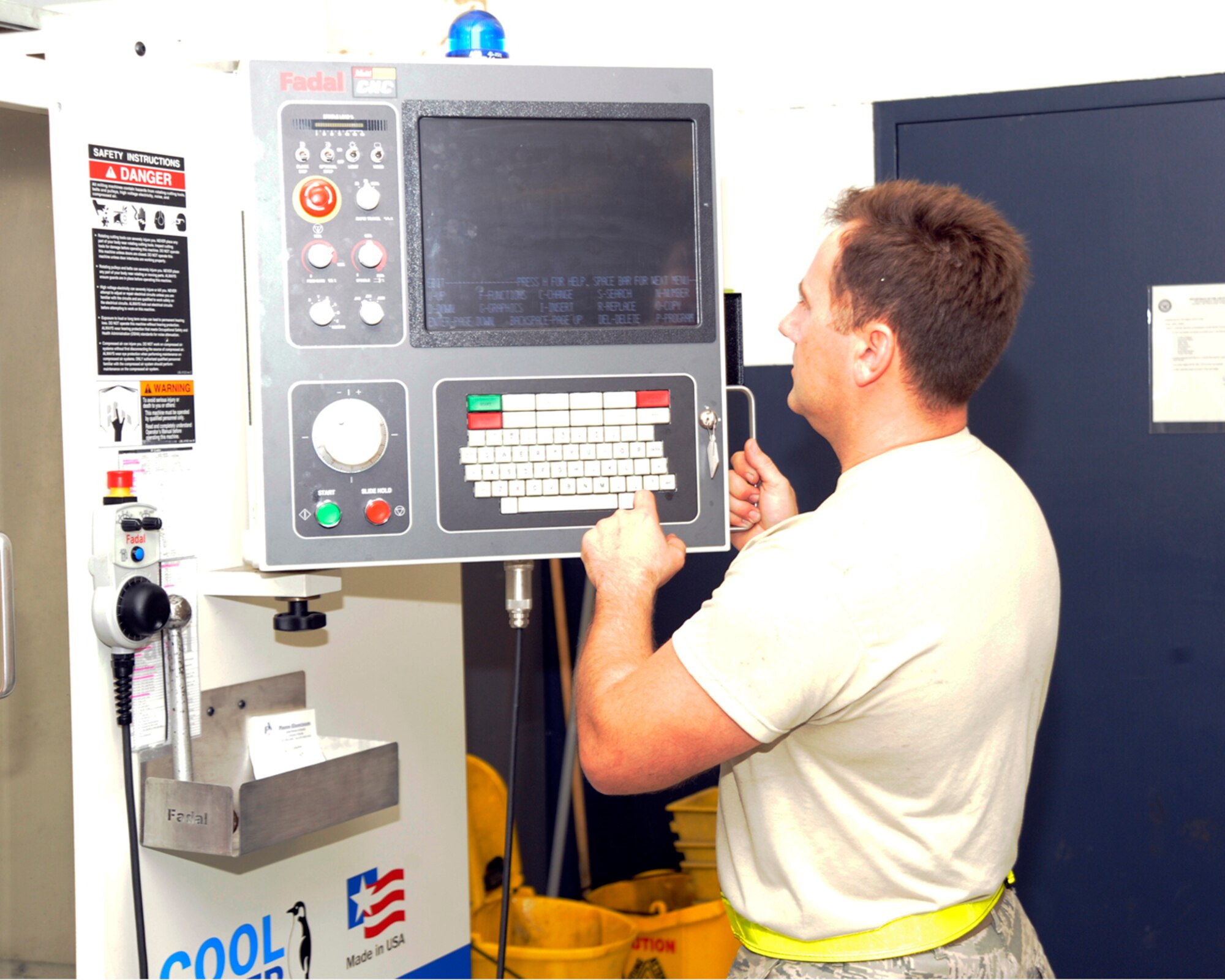 Tech. Sgt. Terry Willis, 6th Maintenance Squadron metals technology craftsman, shows how to use the FADAL machineat the Metals Technology section in Hangar 3 at MacDill.