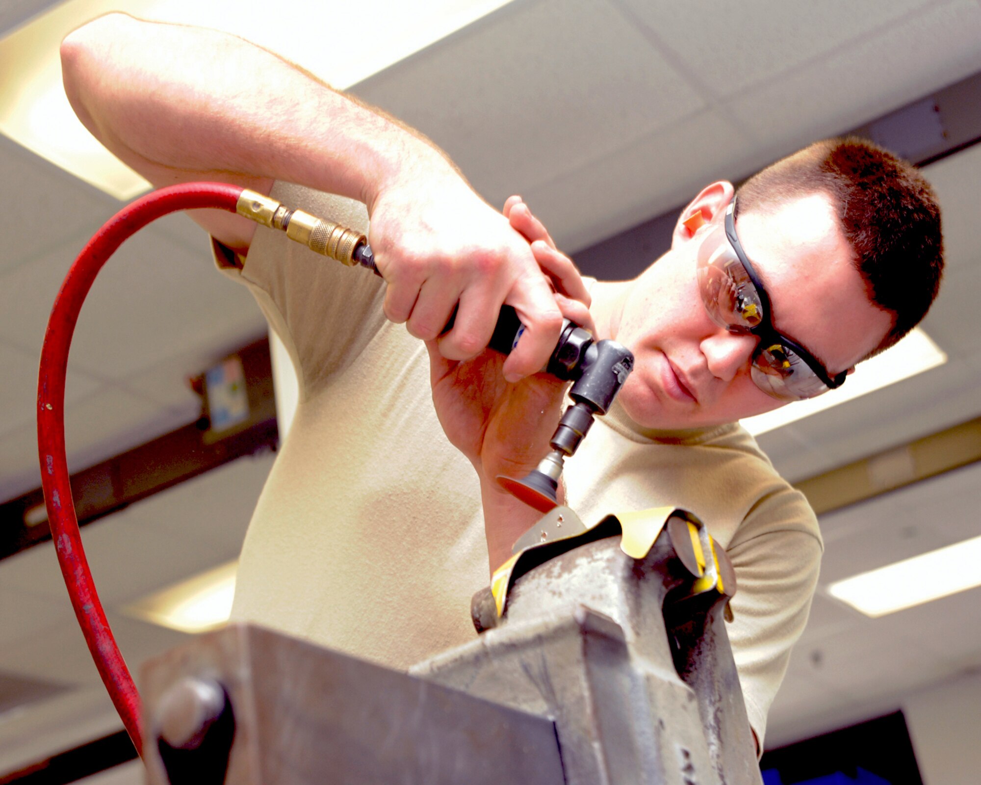 Airman Dominic Mariani, 6th Maintenance Squadron aircraft structural maintenance apprentice, works on a project at the Structural Mainte¬nance site at Hangar 3 recently. Airman Mariani, along with the other members at the 6 MXS Fabrication Flight, helps to mend and maintain the KC-135 Stratotankers at the base.