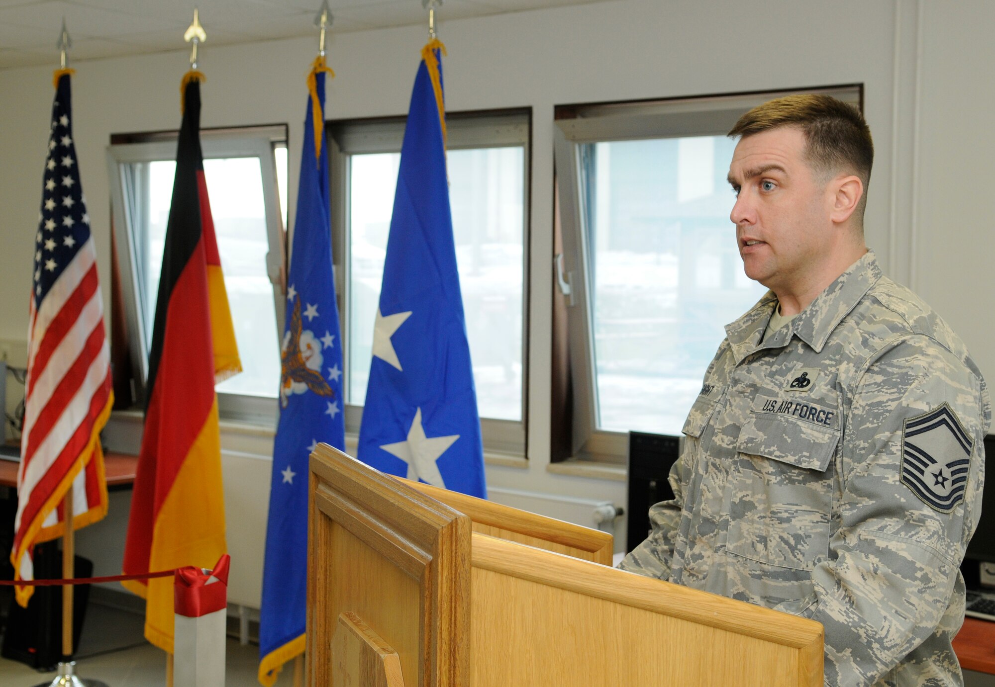 SPANGDAHLEM AIR BASE, Germany – Senior Master Sgt. John Lysaght, 52nd Equipment Maintenance Squadron, makes opening remarks for the opening ceremony of the “Jet Blast” on the flightline Feb. 19. The “Jet Blast” is a facility that will give Airmen on the flightline an opportunity to use wireless Internet, get a haircut, visit a chaplain or eat a hot meal. (U.S. Air Force photo/Senior Airman Benjamin Wilson)