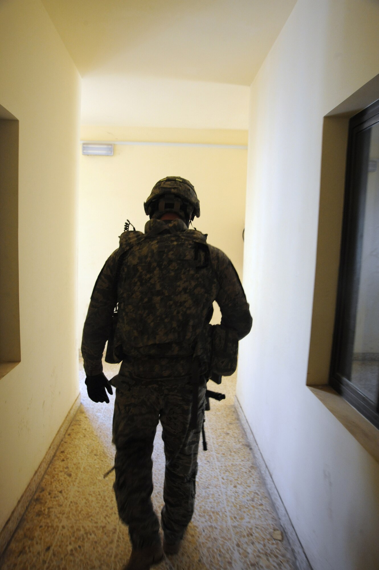 Air Force Staff Sgt. Jared Winker, 732nd Expeditionary Security Forces Squadron Detachment 3 walks through the Iraqi police station after meeting with Iraqi police before conducting a joint polling station assessment Feb 15, 2010.  The purpose of these assessments is to build a rapport between U.S. Forces and the Iraqi police, while providing key insights to force protection at polling sites for the March 7, elections. (U.S. Air Force photo/Master Sgt. Trish Bunting/Released)