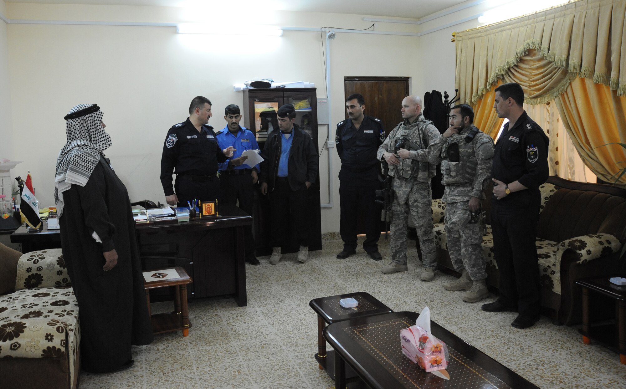Air Force Tech. Sgt. Dennis Kuzel, 732nd Expeditionary Security Forces Squadron Detachment 3, and Nas, 732nd ESFS Det 3 interpreter speak to the Iraqi police before heading to a polling station to conduct a joint polling station assessment Feb. 15, 2010. The purpose of these assessments is to build a rapport between U.S. Forces and the Iraqi police, while providing key insights to force protection at polling sites for the March 7, elections. (U.S. Air Force photo/Master Sgt. Trish Bunting/Released)