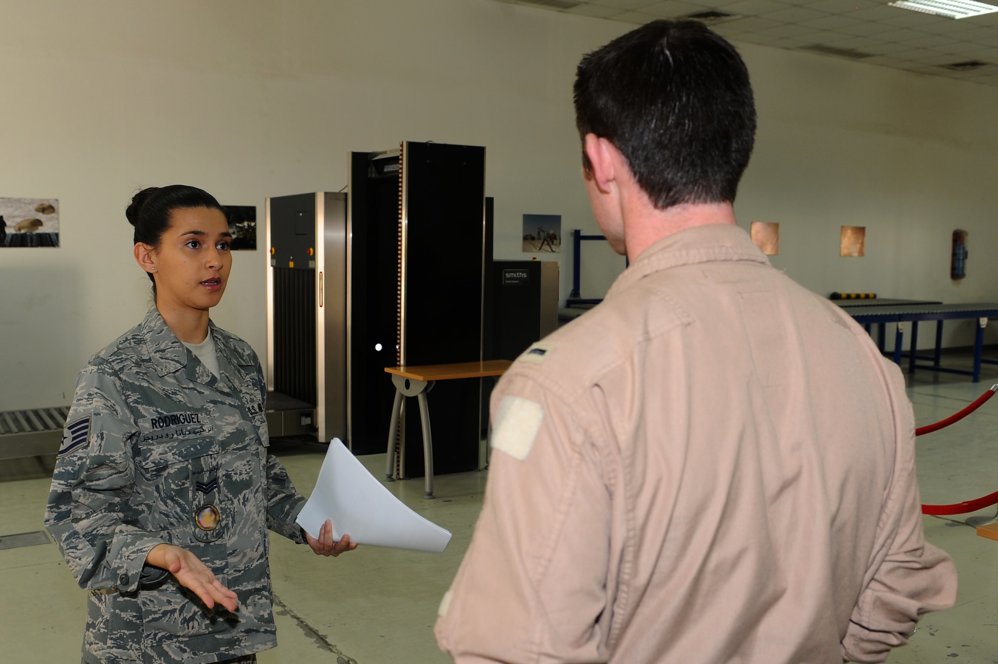 Staff Sgt. Diana Rodriguez, 379th Air Expeditionary Wing host-nation coordination cell liaison, briefs an in-coming pilot on host-nation customs and courtesies at a non-disclosed Southwest Asia location. (U.S. Air Force photo by Senior Airman Kasey Zickmund)[RELEASED]