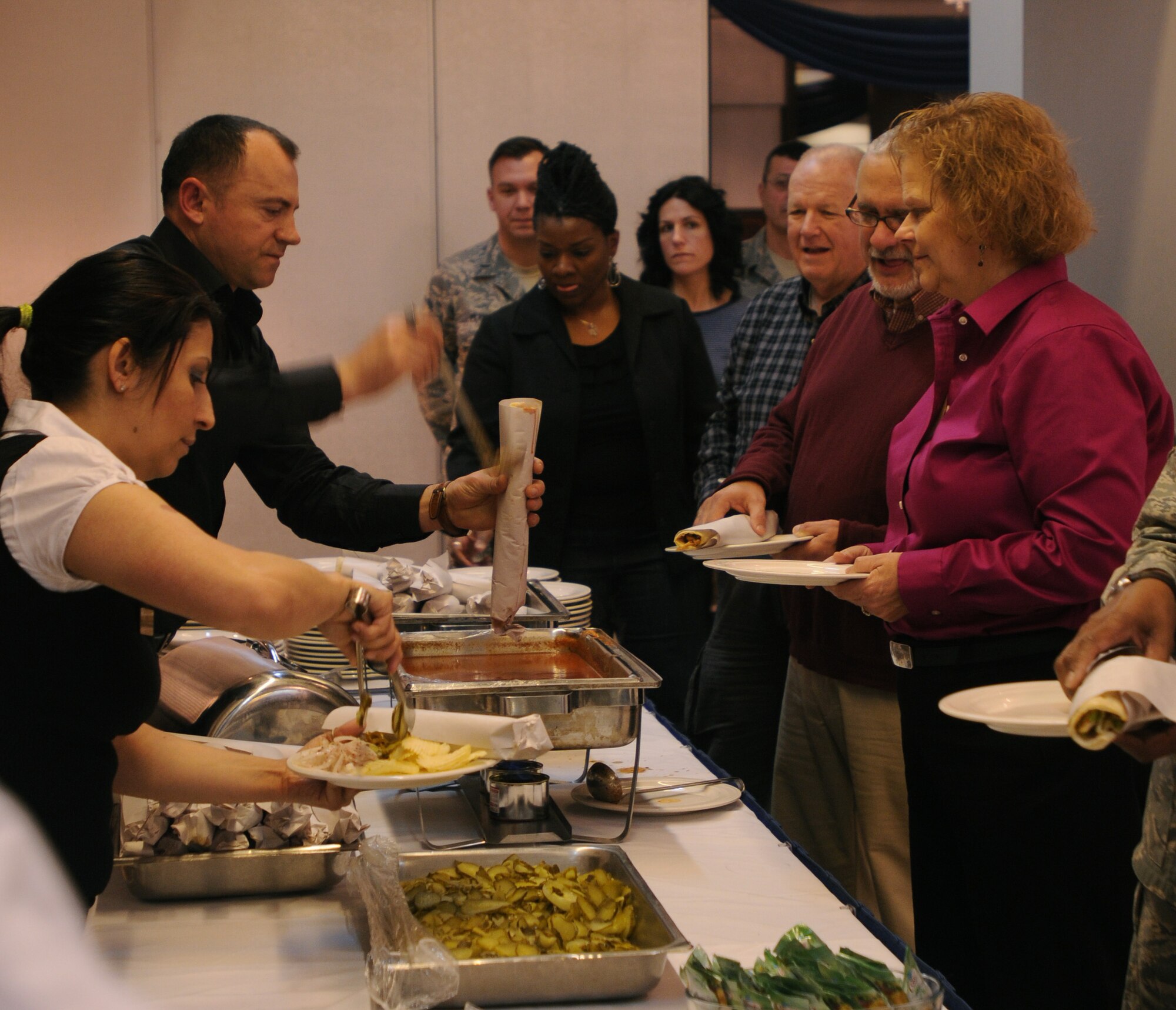 Incirlik Consolidated Club employees help serve 39th Air Base members Thursday, Feb. 18, 2010 during the 2010 National Prayer Observance luncheon at Incirlik AB, Turkey. The luncheon celebrated the National Prayer day with inspirational music from the gospel choir and a speech by guest speaker Chaplain (Brig. Gen.) David Cyr, Air Force deputy chief of chaplains. (U.S. Air Force photo/Airman 1st Class Amber Ashcraft)