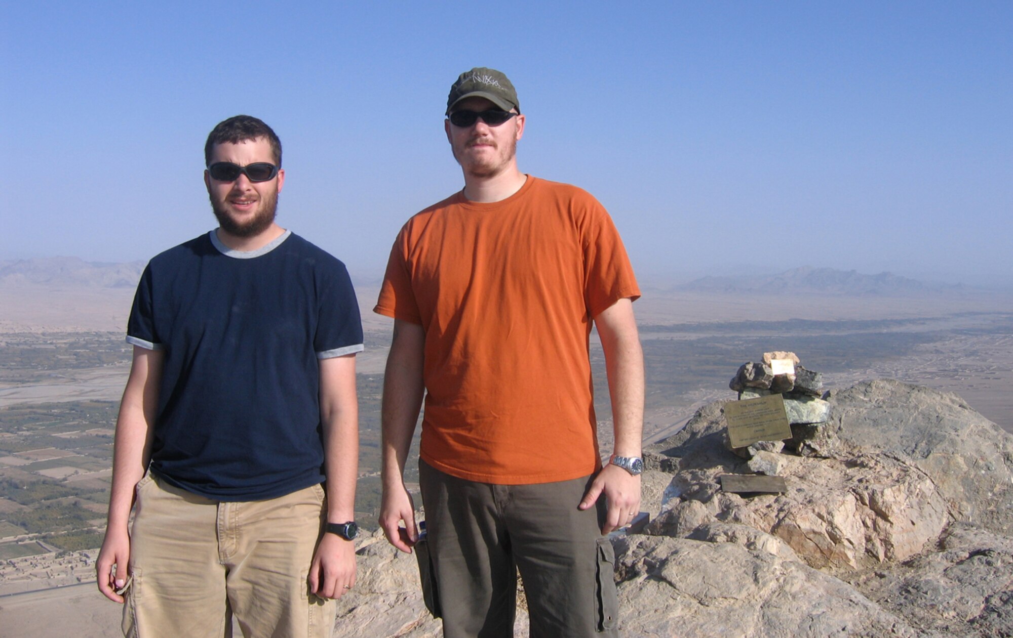 Senior Airman Blasiman. left, 100th Communications Squadron, and coworker Staff Sgt. Greg Shultz, also (formerly) 100th CS, pose at the top of a mountain on Firebase Maholic, during their deployment between September 2008 and February 2009. Airman Blasiman said they were allowed to climb it every Friday morning, and from the top they could see views of Kandahar City and miles around. "I climbed it because I could - and it was a personal challenge I wanted to do," he said. (Courtesy photo)