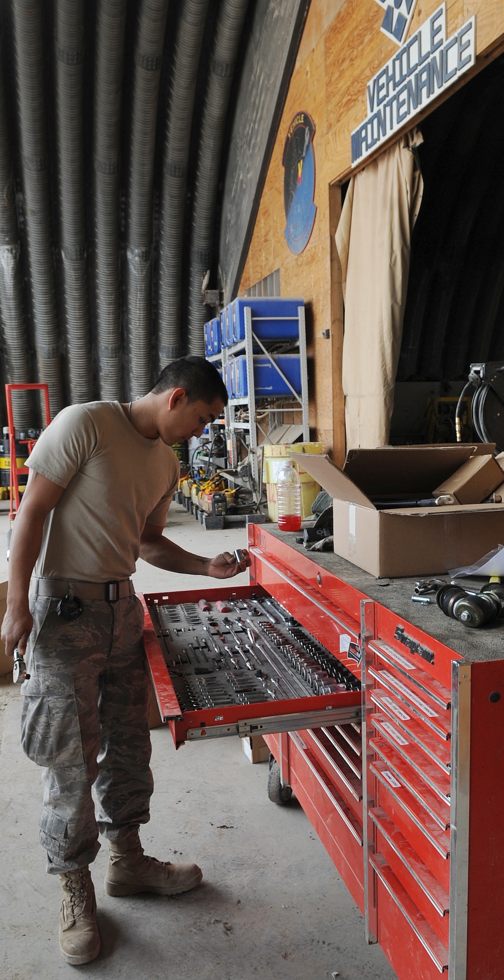 KIRKUK REGIONAL AIR BASE, Iraq –SrA Francisco Macatol, 506th Expeditionary Logistics Readiness Squadron vehicle maintainer, works on a Mine-Resistant Ambush-Protected Vehicle Feb. 12, 2010.  Airmen Macatol is upgrading the MRAP by installing a retro-kit for battery box. The vehicle maintenance shop has a hand in repairing just about any mission essential vehicle on base, including HMMWVs, forklifts, cargo loaders, dodge pickups, ambulances and fire trucks.  (U.S. Air Force photo/Staff Sgt. Tabitha Kuykendall)	    