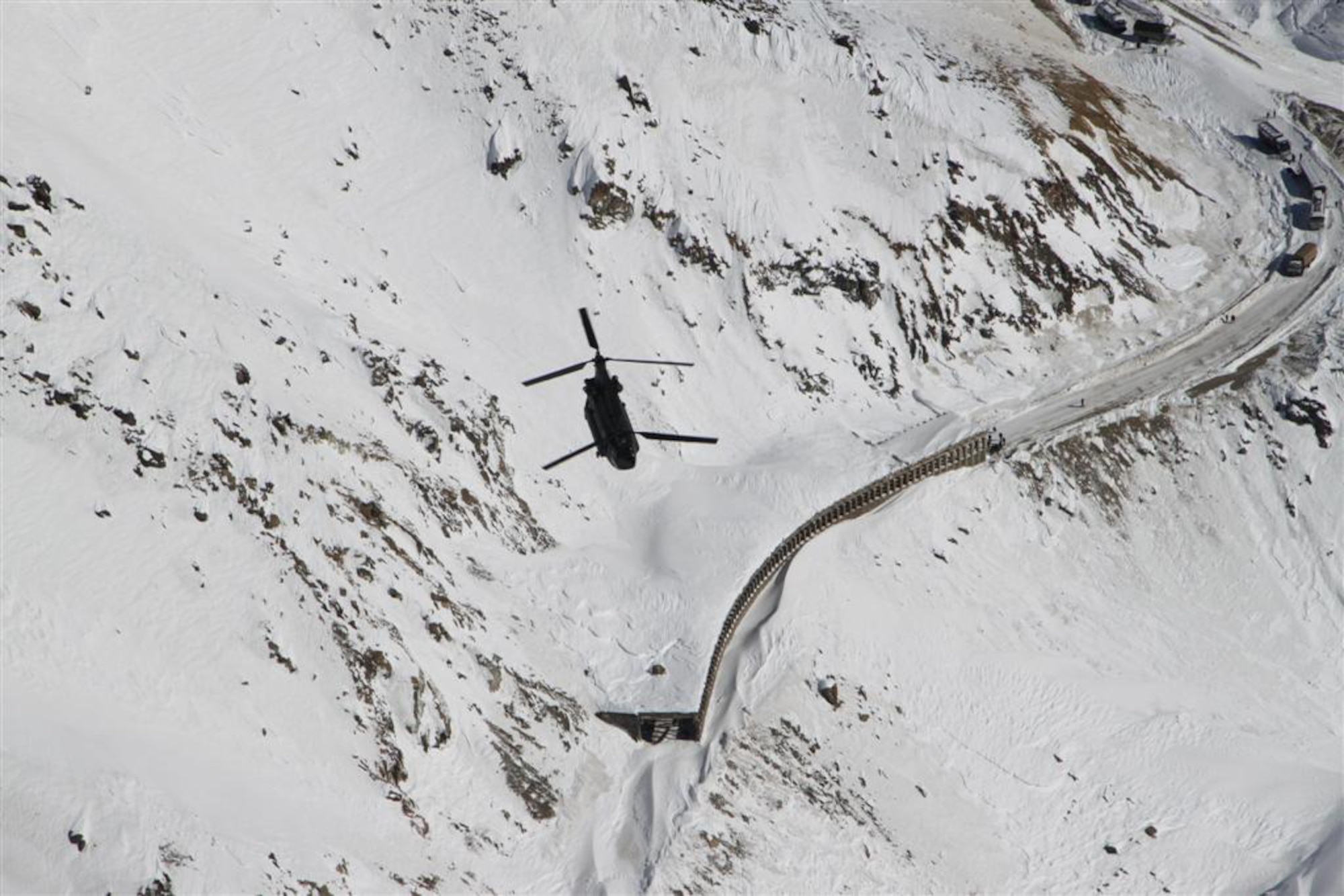 A U.S. Army CH-47 helicopter survey's the area during a rescue operation in the Salang Pass, Afghanistan, Feb. 9, 2010. This type of helicopter completed 12 flights to evacuate Afghans who were stranded by more than 36 avalanches. (Courtesy photo)