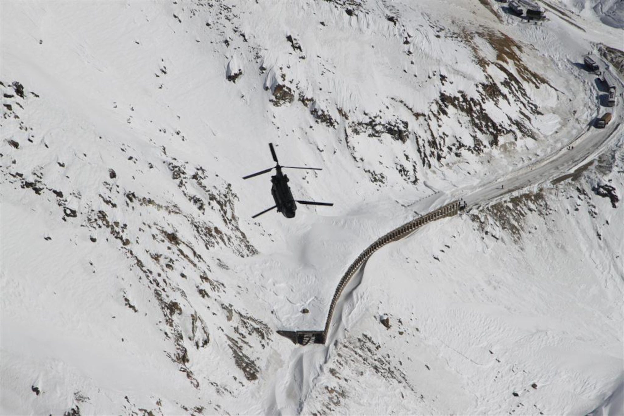 A U.S. Army CH-47 helicopter survey's the area during a rescue operation in the Salang Pass, Afghanistan, Feb. 9, 2010. This type of helicopter completed 12 flights to evacuate Afghans who were stranded by more than 36 avalanches. (Courtesy photo)