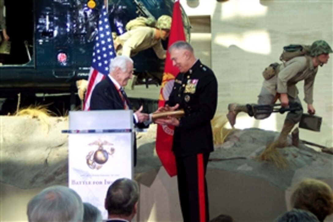 Retired U.S. Marine Corps Lt. Gen. Larry Snowden, chairman of the Iwo Jima Association of America, left, presents U.S. Marine Corps Commandant Gen. James T. Conway  with a war document that he carried home from the Battle of Iwo Jima at the 65th anniversary commemoration of the battle held at the National Museum of the Marine Corps, Triangle, Va., Feb. 19, 2010.  