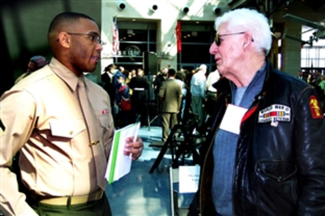 Ron “Rondo” Scharfe, right, a veteran of the Battle of Iwo Jima, talks with a U.S. Marine Corps journalist during the 65th anniversary commemoration of the battle at the National Museum of the Marine Corps, Triangle, Va., Feb. 19, 2010. 