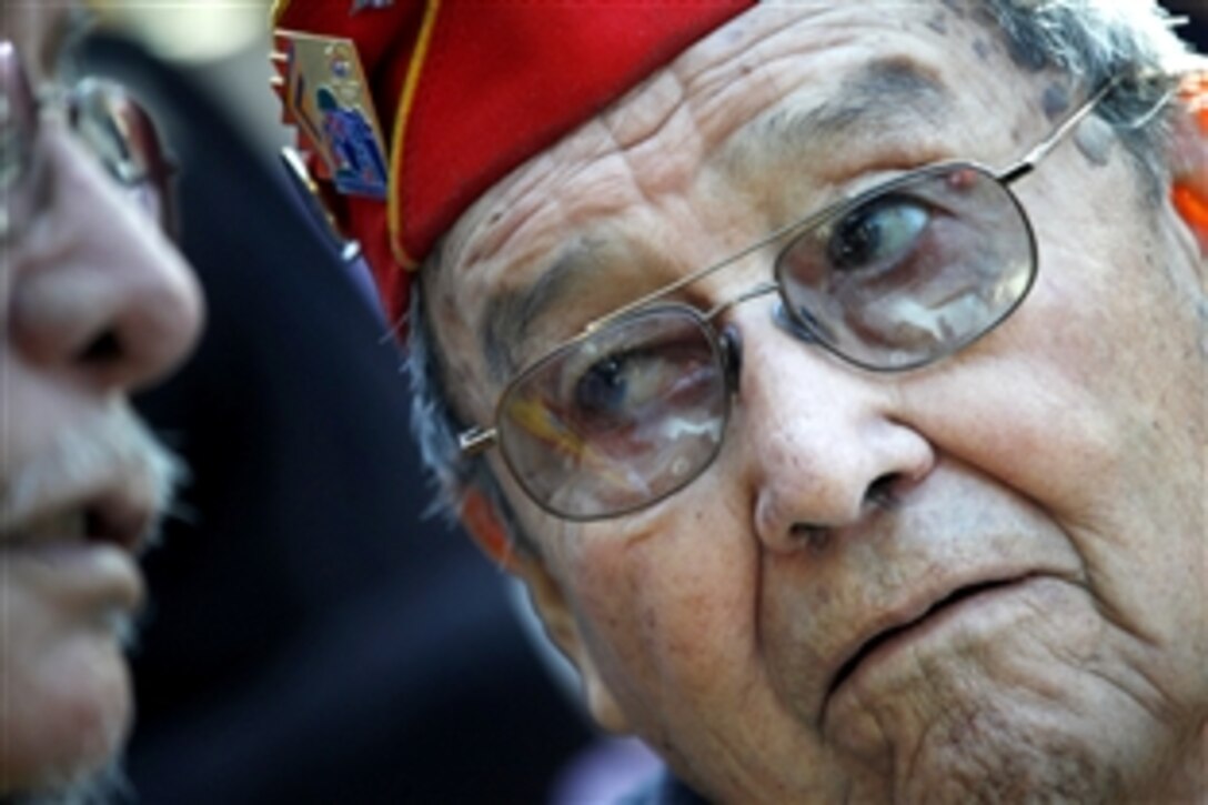 Frank G. Willetto, an 84-year-old Navajo Code Talker, reflects on World War II with a fellow veteran at a ceremony commemorating the 65th anniversary of the Battle of Iwo Jima at the National Museum of the Marine Corps in Triangle, Va., Feb. 19, 2010. In February 1945, the United States launched its first assault against the Japanese at Iwo Jima, resulting in some of the fiercest fighting of the war.