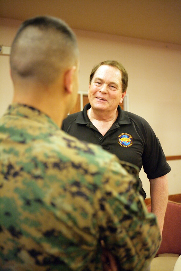 Ken Moore, founder and chief executive officer of Moore's Marauders speaks to Capt. Alexander Vanston about his organization at the Marine Corps Air Station in Yuma, Ariz., Feb. 19, 2010. The organization tracks down the remains of service members listed missing in action. Moore, along with three other representatives from the Marauders, spoke about their mission to bring home America's 92,000 missing service members. "Missing in action is a statement, not an answer," said Moore.