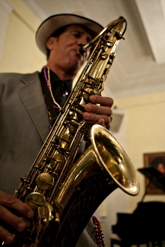 Larry Tanelli, a professional musician, blows out “When the Saints Go Marching In” on the saxophone during the Paradise Point Officers’ Club’s Mardi Gras Masquerade, Feb. 20.