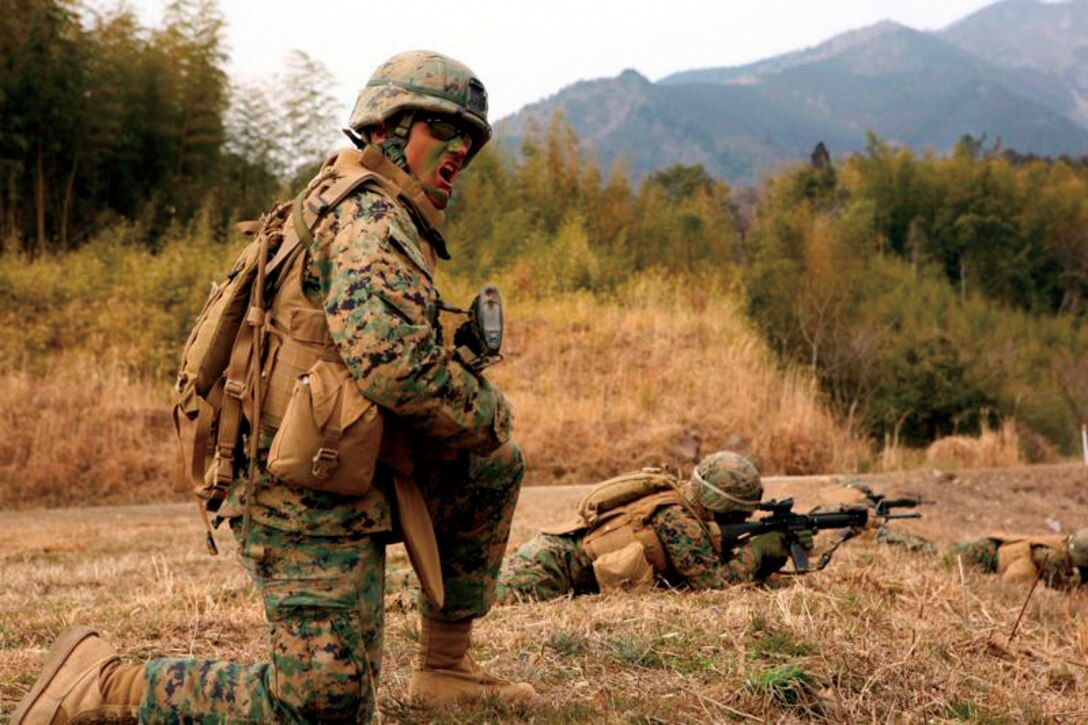 Cpl. Samuel. M. Bebout, a combat engineer with Combat Engineer Company, Combat Assault Battalion, 3rd Marine Regiment, 3rd Marine Division, III Marine Expeditionary Force, yells commands to his squad during a live-fire assault training exercise Monday. The exercise was part of Forest Light, a bilateral training exercise at Nihonbara Training Area, Japan, between U.S. Marines and Japan Ground Self-Defense Force soldiers. This exercise affords U.S. Marines and Japanese soldiers an opportunity to observe and learn from each others tactics.