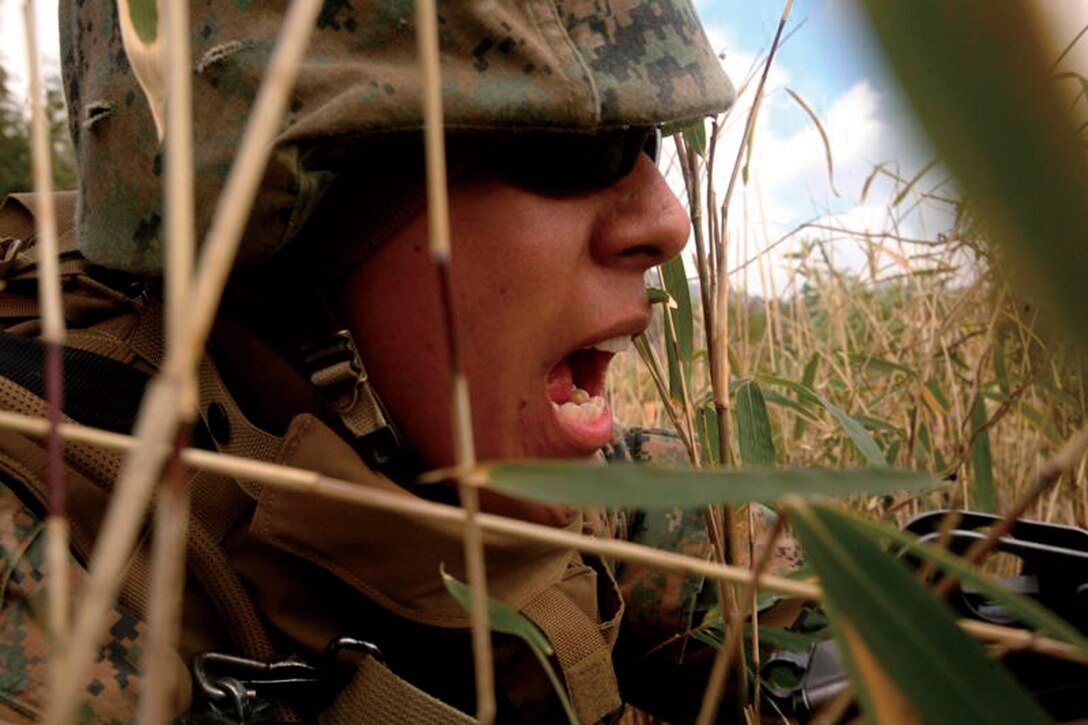 Pfc. Efren Swaste, a combat engineer with Combat Engineer Co., CAB, yells 'Bang,' simulating machine gun fire during suppressive fire training Feb. 20 at Nihonbara Training Area during Exercise Forest Light.