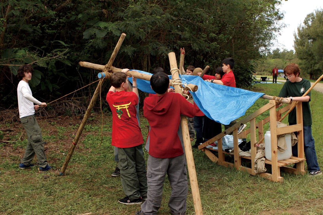 Boy Scouts work as a team to build a shelter out of supplies carried on their sled. The stations of the Klondike Derby tested the Scouts' proficiency in first-aid, navigation, making a shelter, translating Morse code and various other skills.