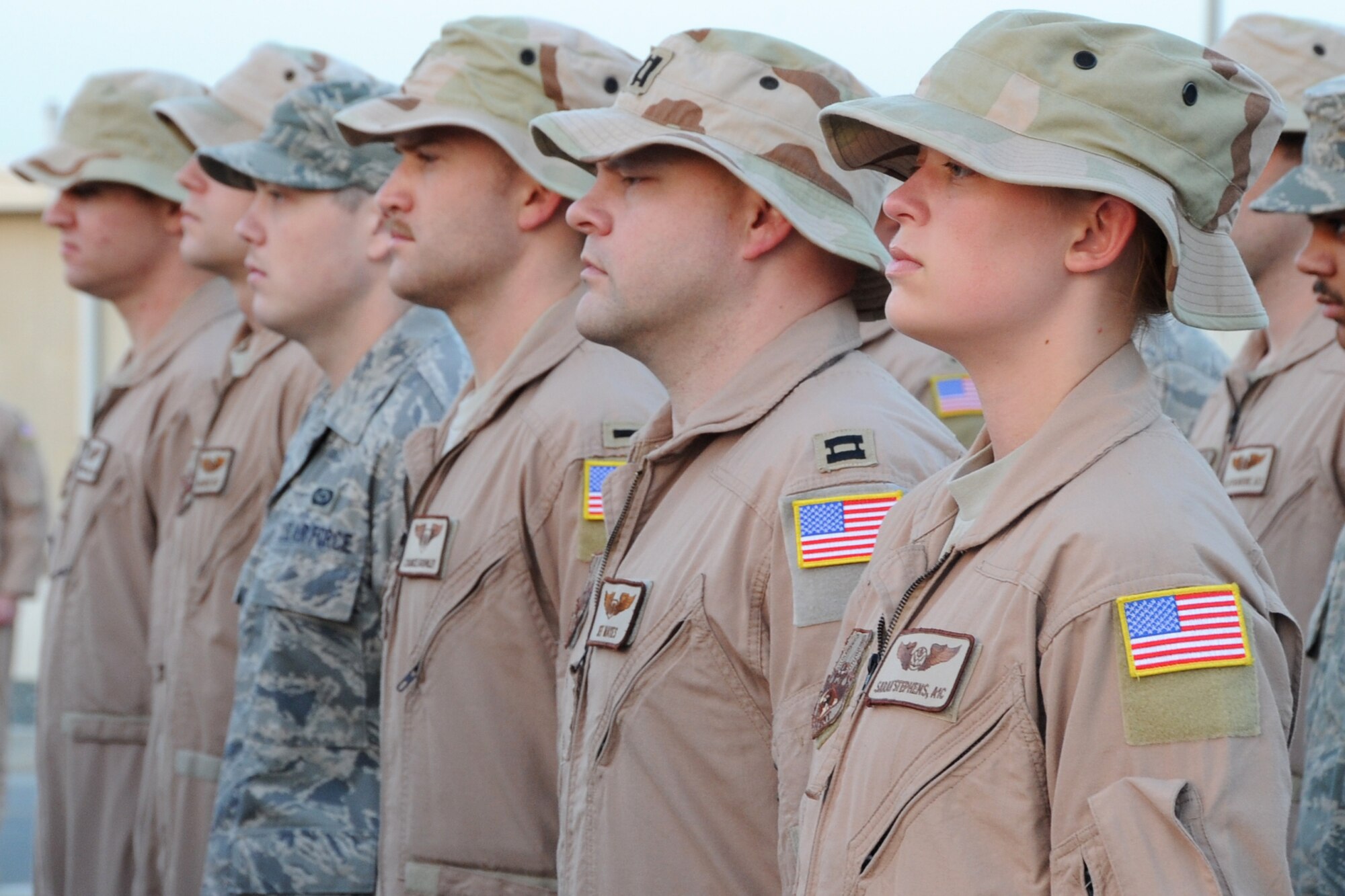Members of the 965th Expeditionary Airborne Air Control Squadron stand at the position of attention during retreat at an undisclosed location in Southwest Asia on Feb. 19, 2010.  Airmen from across the 380th Air Expeditionary Wing join every week to pay respect during retreat. (U.S. Air Force photo/Senior Airman Jenifer H. Calhoun/Released)
