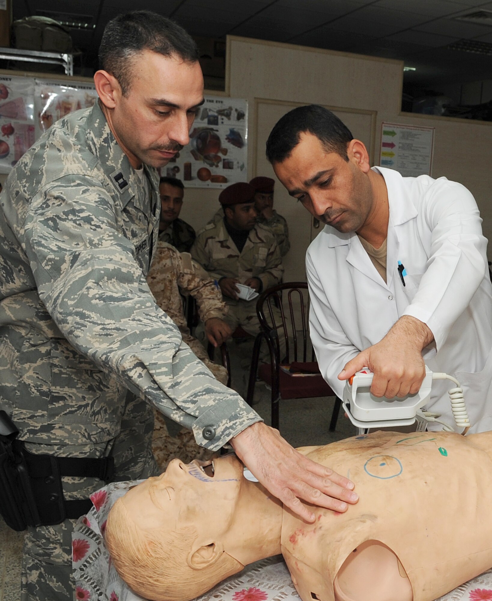 KIRKUK REGIONAL AIR BASE, Iraq – Capt.  Adam Christopher and Staff Sgt. Andrew Salas, 506th Expeditionary Medical Squadron, teach Iraqi medics how to use a defibrillator Feb. 16, 2010.  This training is part of the Expert Field Medical "Batch" four-week course offered to Iraqi medics at the K-1 Iraqi medical clinic in order to provide the experience they will need in real-world situations. The IEFMB training is another step toward Iraqi independence.  (U.S. Air Force photo/Staff Sgt. Tabitha Kuykendall)