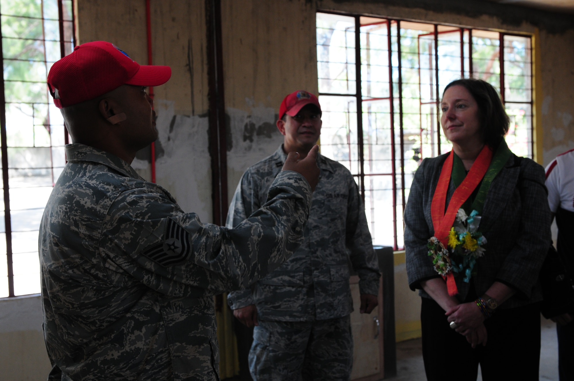 Tech. Sgt. Bernard Mallada explains to Ms. Leslie Bassett, the acting U.S. Ambassador the Philippines, the details of construction work conducted at Caaoacan Elementary School in Laoag, Philippines. Ms. Bassett toured several Operation Pacific Angel civic assistance program sites during her vist Feb. 20. Sergent Mallada is from the 254th Red Horse Squadron from Andersen Air Force Base, Guam.