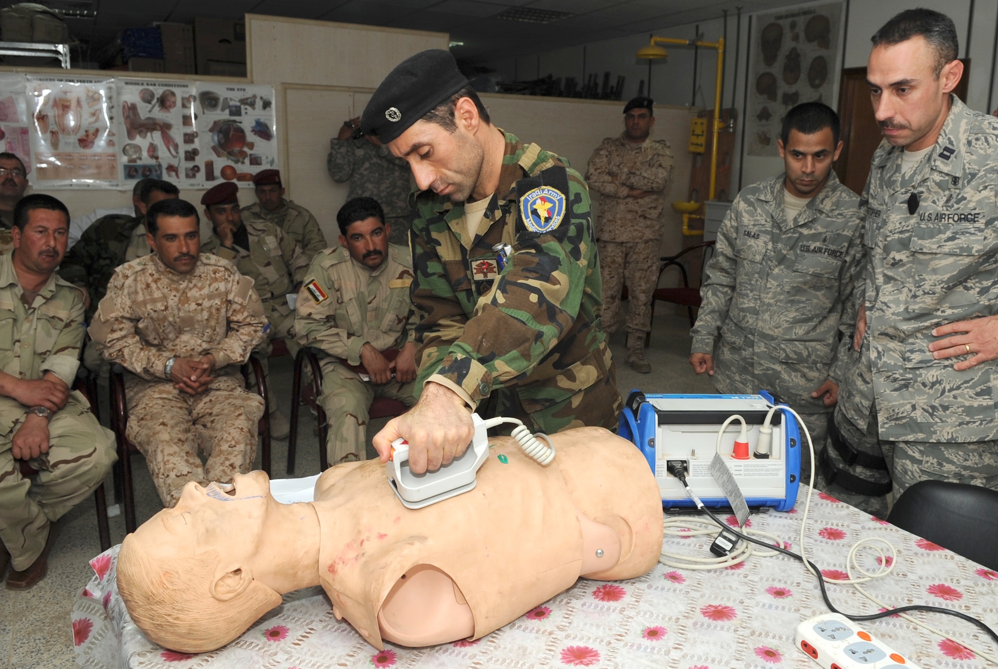 KIRKUK REGIONAL AIR BASE, Iraq – Capt.  Adam Christopher and Staff Sgt. Andrew Salas, 506th Expeditionary Medical Squadron, teach Iraqi medics how to use a defibrillator Feb. 16, 2010.  This training is part of the Expert Field Medical Batch four-week course offered to Iraqi medics at the K-1 Iraqi medical clinic in order to provide the experience they will need in real-world situations. The IEFMB training is another step toward Iraqi independence.  (U.S. Air Force photo/Staff Sgt. Tabitha Kuykendall)