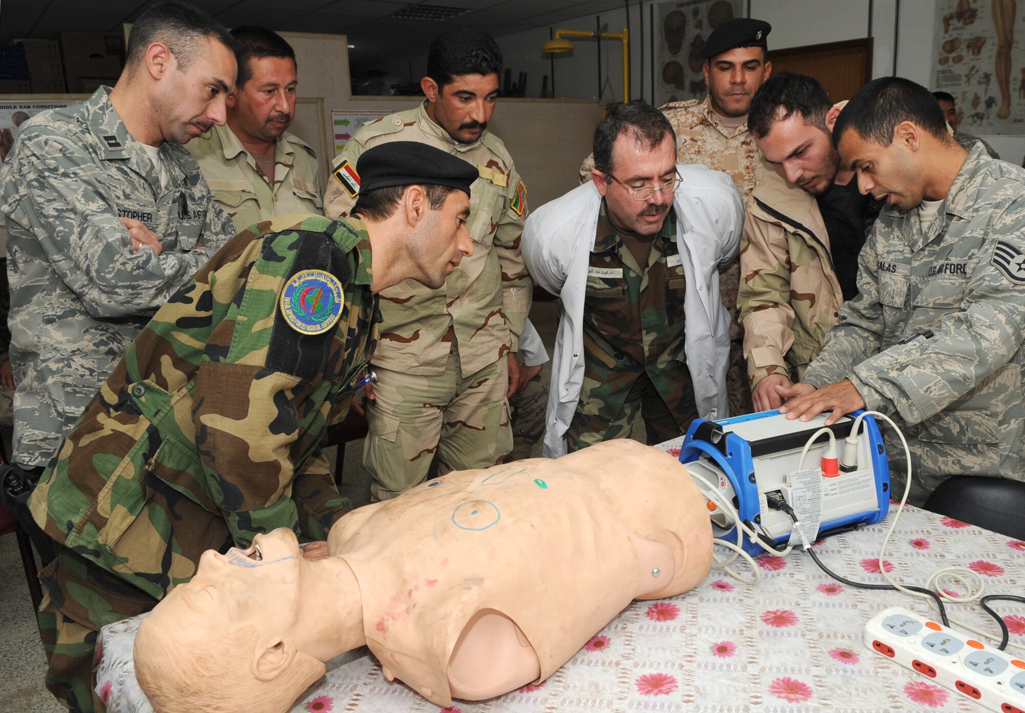 Capt. Adam Christopher and Staff Sgt. Andrew Salas, 506th Expeditionary Medical Squadron, teach Iraqi medics how to use a defibrillator at Kirkuk Regional Air Base, Iraq on Feb. 16, 2010.  This training is part of the Expert Field Medical Batch four-week course offered to Iraqi medics at the K-1 Iraqi medical clinic in order to provide the experience they will need in real-world situations. The IEFMB training is another step toward Iraqi independence.  (U.S. Air Force photo/Staff Sgt. Tabitha Kuykendall/Released)