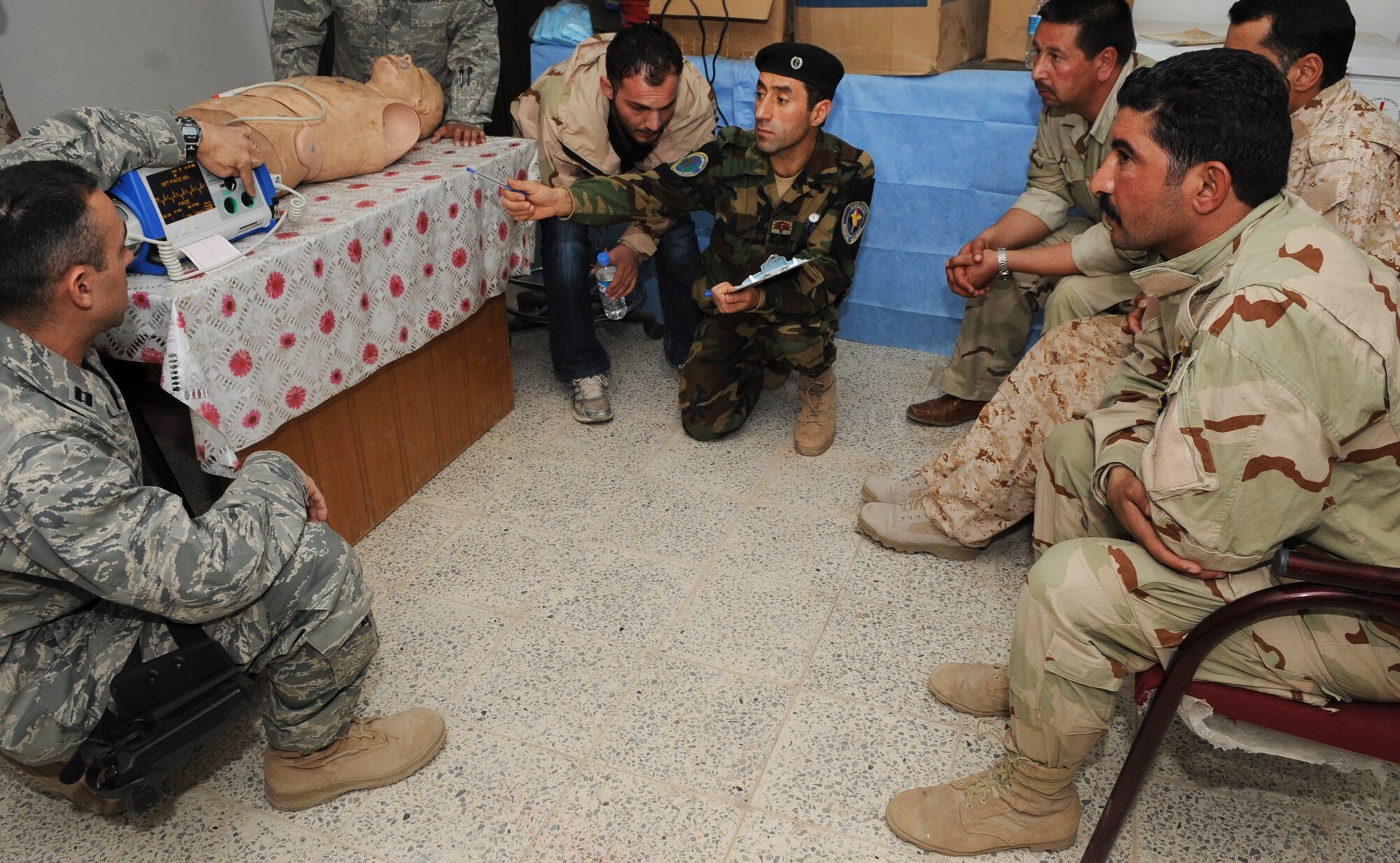 KIRKUK REGIONAL AIR BASE, Iraq – Capt.  Adam Christopher and Staff Sgt. Andrew Salas, 506th Expeditionary Medical Squadron, teach Iraqi medics how to use a defibrillator Feb. 16, 2010.  This training is part of the Expert Field Medical Batch four-week course offered to Iraqi medics at the K-1 Iraqi medical clinic in order to provide the experience they will need in real-world situations. The IEFMB training is another step toward Iraqi independence.  (U.S. Air Force photo/Staff Sgt. Tabitha Kuykendall)