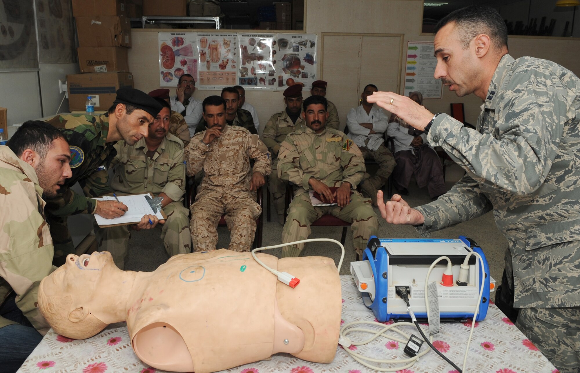 KIRKUK REGIONAL AIR BASE, Iraq – Capt.  Adam Christopher and Staff Sgt. Andrew Salas, 506th Expeditionary Medical Squadron, teach Iraqi medics how to use a defibrillator Feb. 16, 2010.  This training is part of the Expert Field Medical Batch four-week course offered to Iraqi medics at the K-1 Iraqi medical clinic in order to provide the experience they will need in real-world situations. The IEFMB training is another step toward Iraqi independence.  (U.S. Air Force photo/Staff Sgt. Tabitha Kuykendall)