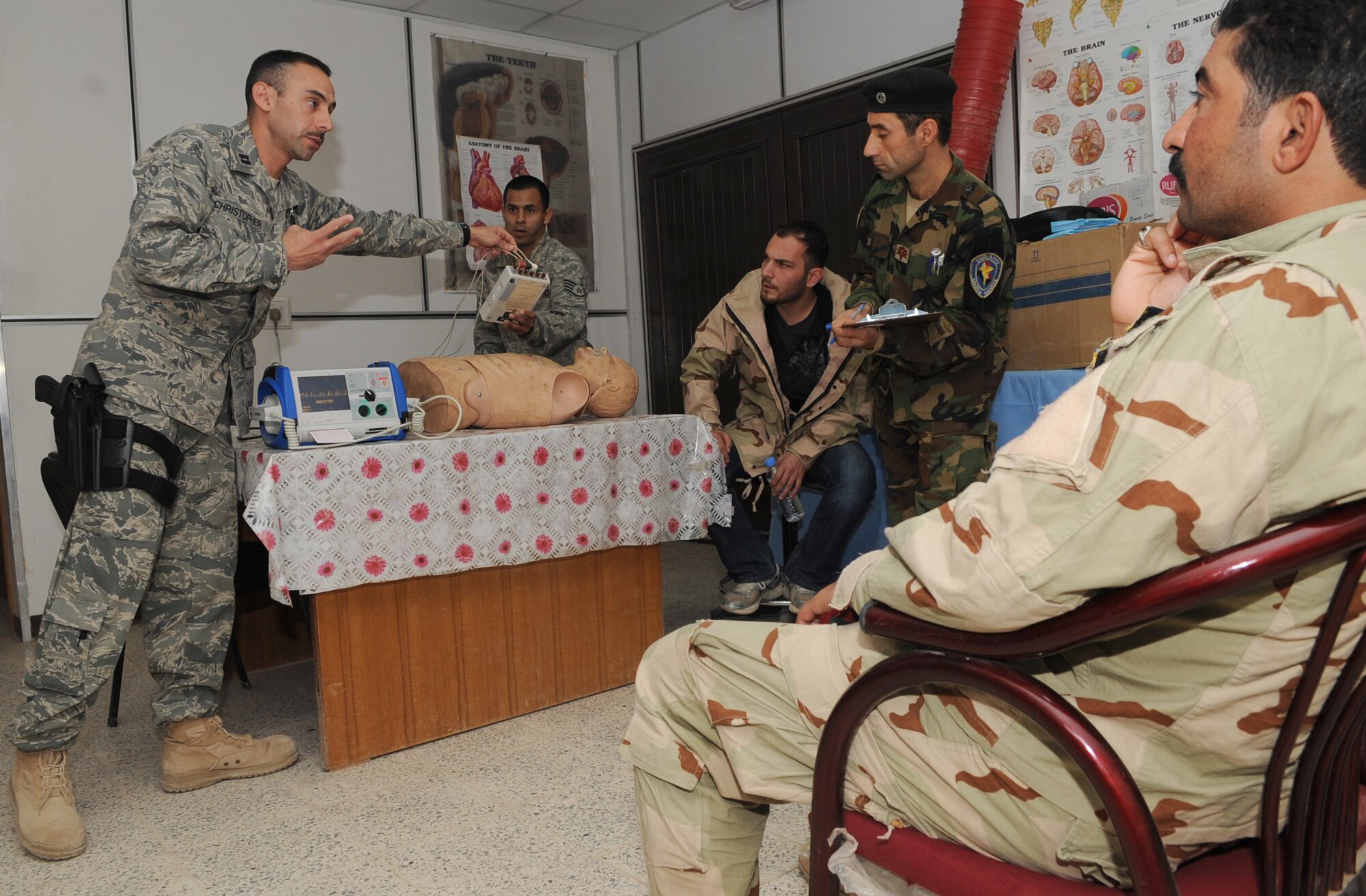 KIRKUK REGIONAL AIR BASE, Iraq – Capt.  Adam Christopher and Staff Sgt. Andrew Salas, 506th Expeditionary Medical Squadron, teach Iraqi medics how to use a defibrillator Feb. 16, 2010.  This training is part of the Expert Field Medical Batch four-week course offered to Iraqi medics at the K-1 Iraqi medical clinic in order to provide the experience they will need in real-world situations. The IEFMB training is another step toward Iraqi independence.  (U.S. Air Force photo/Staff Sgt. Tabitha Kuykendall)