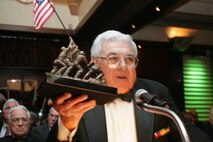 Angelo Ciotta, president of the Iwo Jima Survivors of New York, presents a statue of the flag raising at Iwo Jima, an iconic Marine Corps battle, to fellow Iwo Jima veterans at the 2010 Iwo Jima Survivors of New York Dinner, February 20, 2010 at the Chateau Briand, Carle Place, New York.  The memorial dinner was hosted by Hope for the Warriors, in honor of the 65th Anniversary of the battle of Iwo Jima. (Official Marine Corps photo by Staff Sgt. Alana M. Pereira)