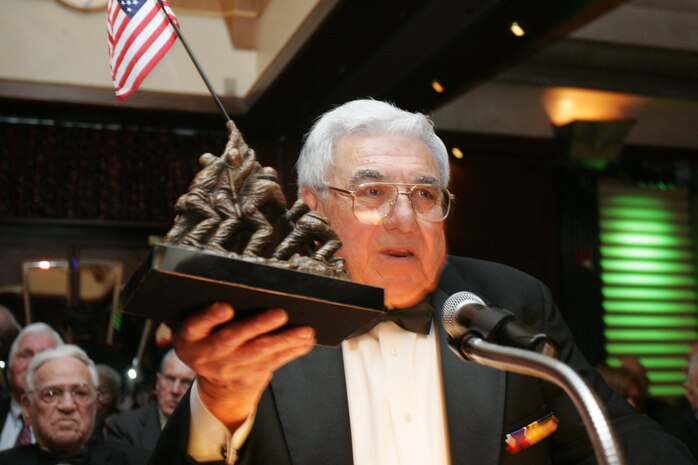 Angelo Ciotta, president of the Iwo Jima Survivors of New York, presents a statue of the flag raising at Iwo Jima, an iconic Marine Corps battle, to fellow Iwo Jima veterans at the 2010 Iwo Jima Survivors of New York Dinner, February 20, 2010 at the Chateau Briand, Carle Place, New York.  The memorial dinner was hosted by Hope for the Warriors, in honor of the 65th Anniversary of the battle of Iwo Jima. (Official Marine Corps photo by Staff Sgt. Alana M. Pereira)