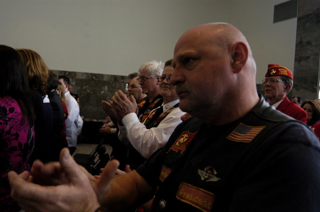 Columbus based Marine Riders applaud as Cpl. Daniel Gire receives the Silver Star Medal from Lt. Gen. John Kelly during a ceremony at the Veterans Memorial in Columbus, Ohio Feb. 20.