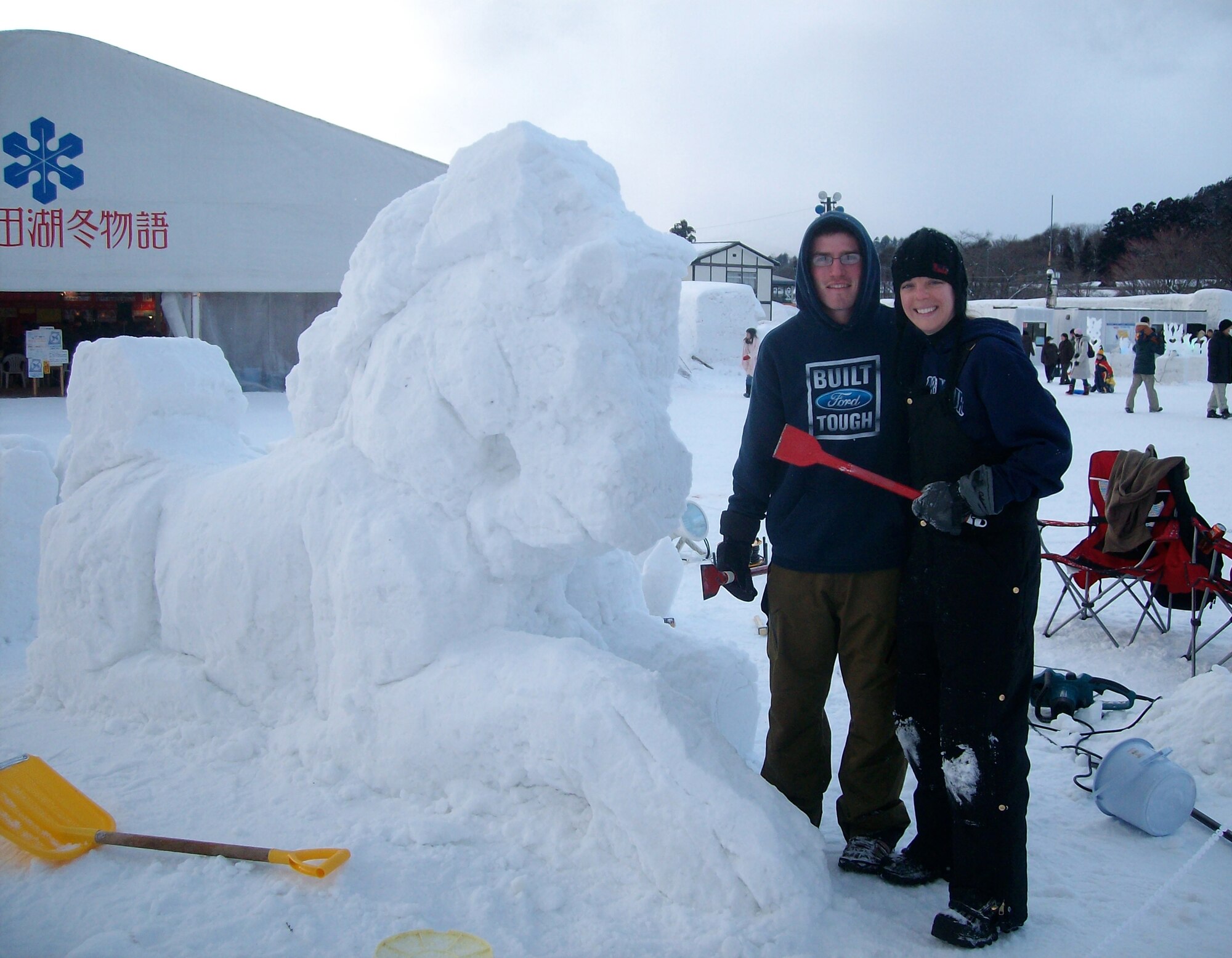Senior Airman Kyle Meister and his wife, Erika, stand next to their sculpted unicorn during the Towada City Snow and Light Fantavista. (courtesy photo)