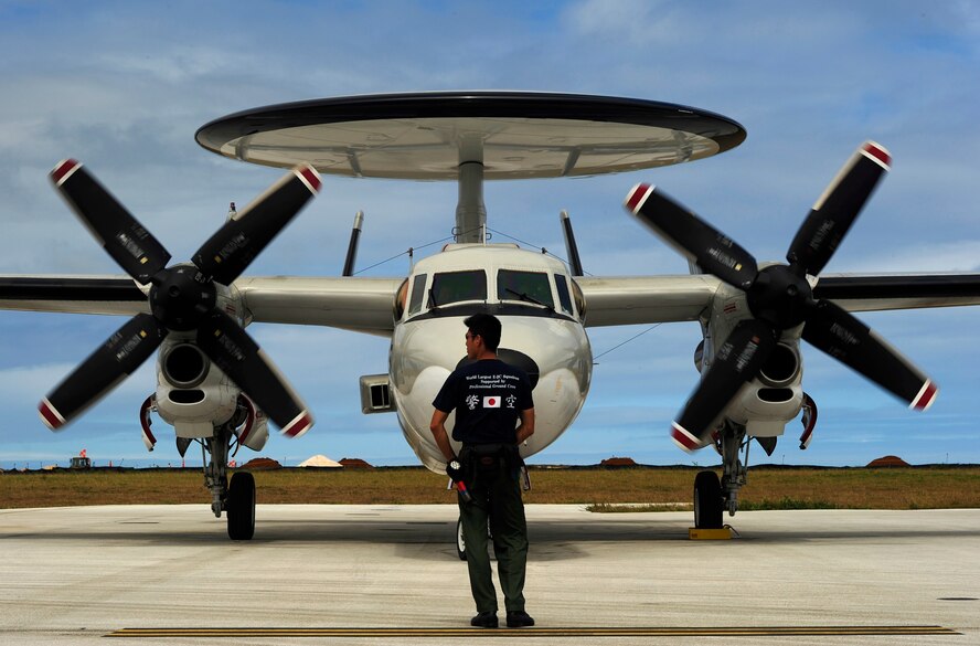 An E-2C Hawkeye aircraft crew chief from 601st Squadron, Airborne Early Warning Group, Misawa Air Base, Japan, directs an E-2C into an aircraft parking spot at Andersen Air Force Base, Guam, during Exercise Cope North, Feb. 18, 2010. The United States Air Force and the Japan Air Self-Defense Force conduct Cope North annually at Andersen Air Force Base to increase combat readiness and interoperability, concentrating on coordination and evaluation of air tactics, techniques and procedures. The ability for both nations to work together increases their preparedness to support real-world contingencies. (U.S. Air Force photo by Staff Sgt. Jacob N. Bailey / Released)