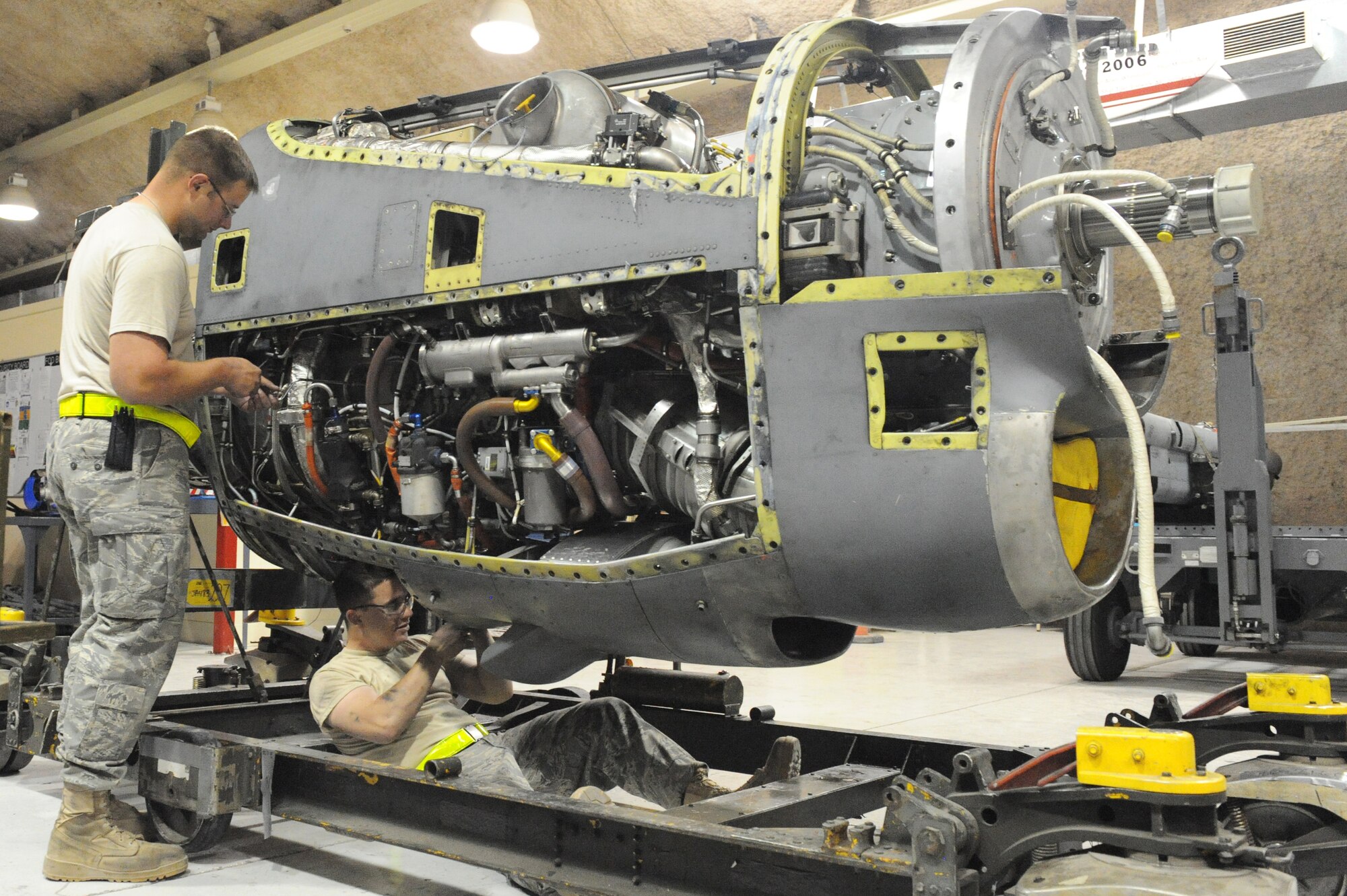 Staff Sgt. Benjamin Campbell and Airman 1st Class Michael Morrison, 379th Expeditionary Maintenance Squadron aerospace propulsion technicians, perform finishing touches on a C-130 engine prior to operational testing at a non-disclosed Southwest Asia location, Feb 17, 2010. (U.S. Air Force photo by Tech. Sgt. Michelle Larche)[RELEASED]