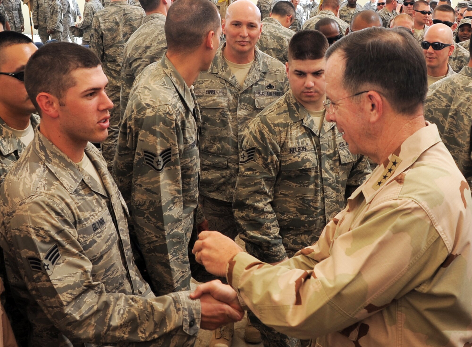 Senior Airman Matthew Glynn, 380th Expeditionary Communications Squadron, shakes hands with U.S. Navy Adm. Mike Mullen, Chairman of the Joint Chiefs of Staff, during a visit to the 380th AEW by Admiral Mullen on Feb. 18, 2010, to a non-disclosed base in Southwest Asia.  (U.S. Air Force Photo/Master Sgt. Scott T. Sturkol/Released)