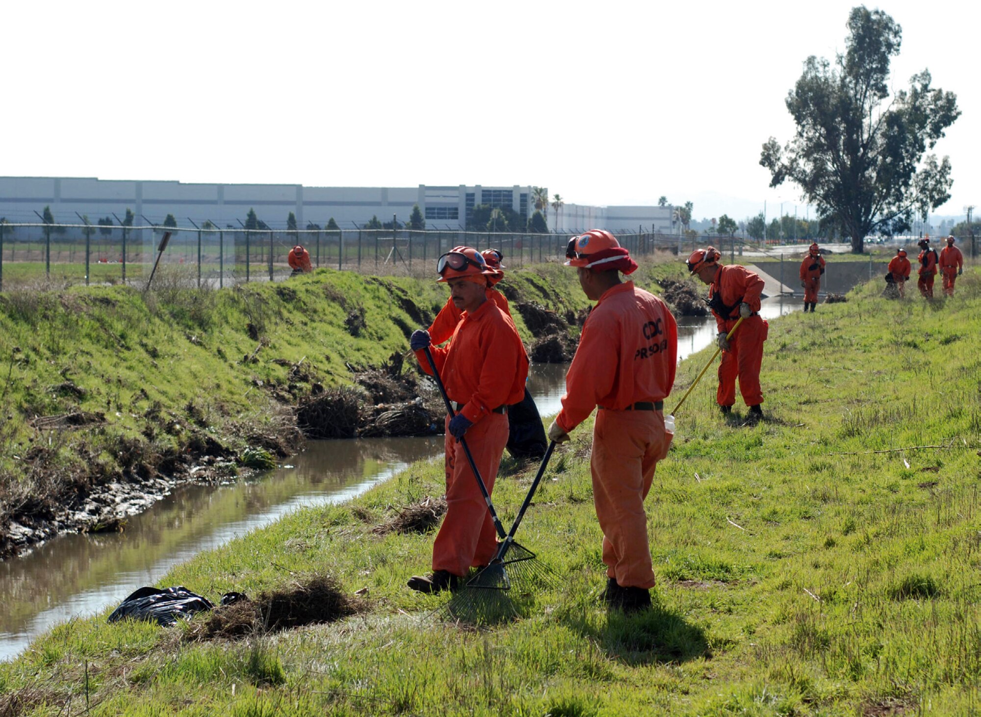 Members of the Oak Glen Conservation Camp Crew 4 put the finishing touches on their two-week drainage ditch clean up project at March Air Reserve Base, Feb. 10. Keeping the ditches free of debris is crucial for flood control on the base. ( U.S. Air Force photo by Staff Sgt. Kevin Chandler)