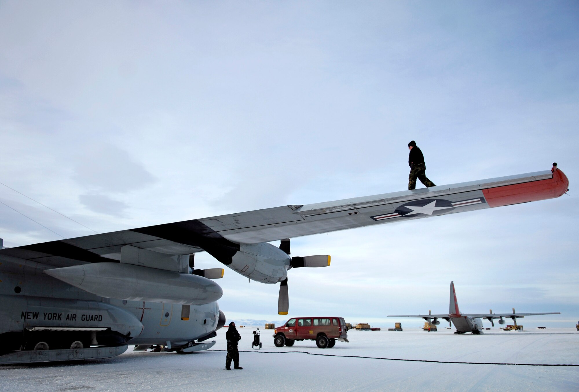In this file photo, a maintenance crew conducts a post-flight check of an LC-130 Hercules on the ice runway near McMurdo Station, Antarctica, during Operation Deep Freeze. Ski-equipped LC-130s, crews and support personnel from the New York Air National Guard's 109th Airlift Wing support the 13th Air Force-led Joint Task Force Support Forces Antarctica. (U.S. Air Force photo/Tech. Sgt. Shane A. Cuomo)