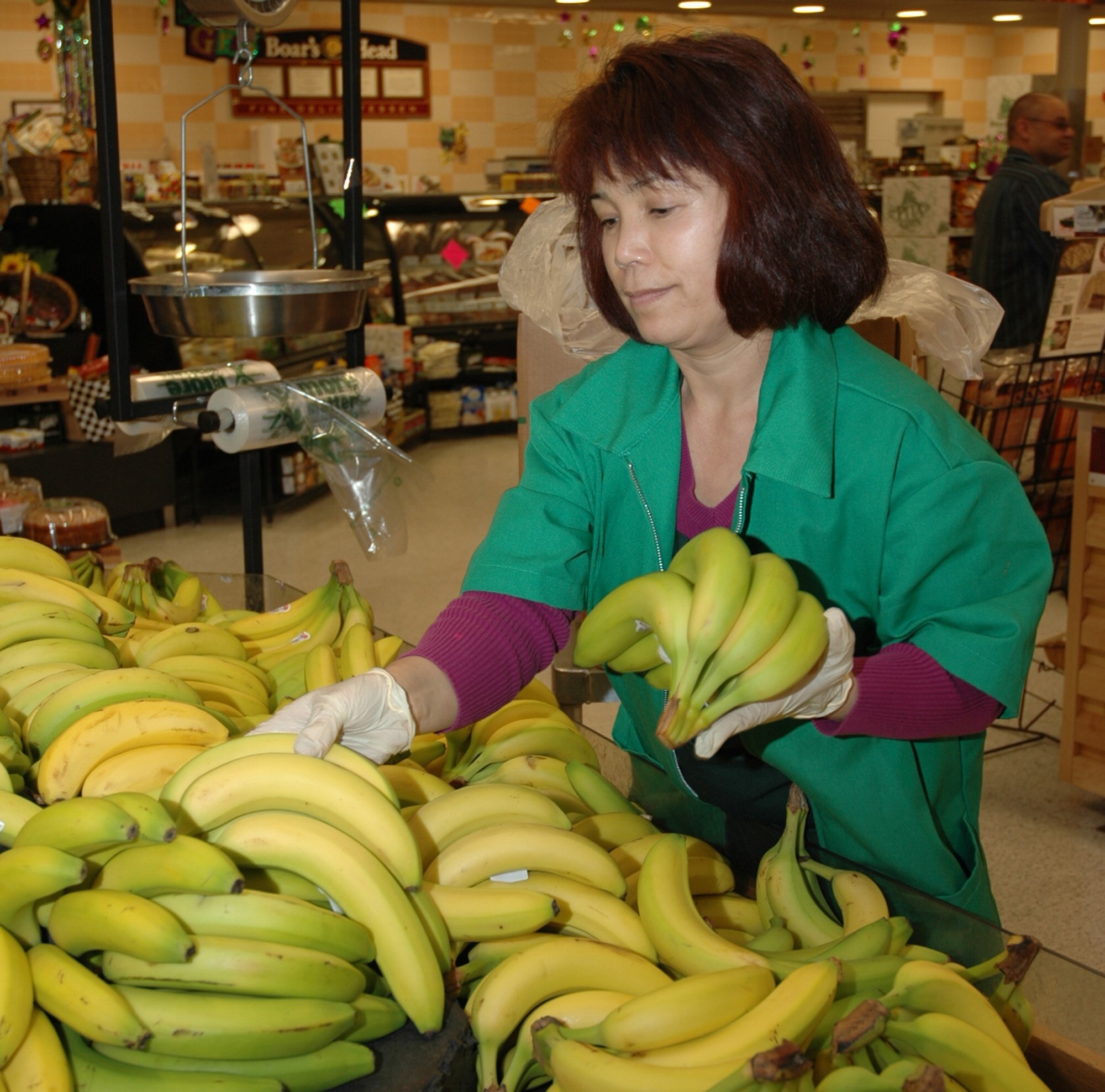 Chong Yale, a produce employee, stocks a new selection of bananas at the Hurlburt Field Commissary Feb. 18. The Defense Commissary Agency is partnering with the Department of Defense's 'Military Saves Week' Feb. 21-28 to raise awareness about the benefits of becoming financial fit. (U.S. Air Force photo by Airman Caitlin O'Neil-McKeown)