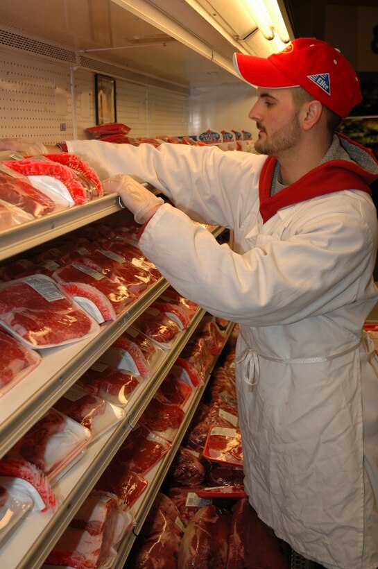 Justin Pifer, a meat market employee, sorts out a selection of steaks at the Hurlburt Field Commissary Feb. 18. The Defense Commissary Agency is partnering with the Department of Defense's 'Military Saves Week' Feb. 21-28 to raise awareness about the benefits of becoming financial fit. (U.S. Air Force photo by Airman Caitlin O'Neil-McKeown)