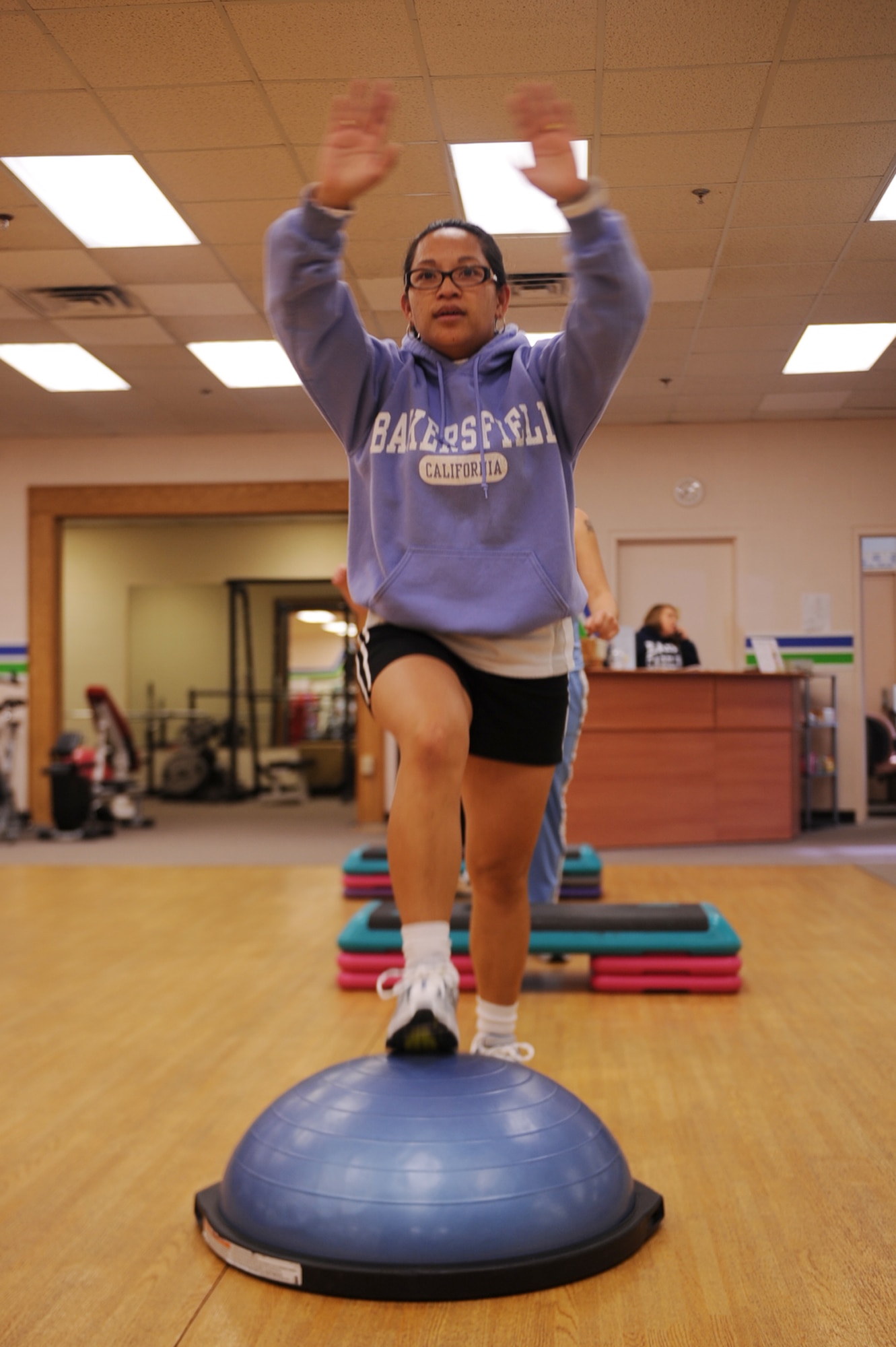 Regina Henderson, wife of Tech. Sgt. Frank Henderson, 4th Aerospace Medicine Squadron non-commissioned officer in charge of bioenvironmental, performs advanced stepping during a cardio challenge class at Bellamorphosis women's health center on Seymour Johnson Air Force Base, N.C., Feb. 22, 2010.  Bellamorphosis offers aerobic and toning classes, as well as free babysitting during member workouts. (U.S. Air Force photo/Senior Airman Ciara Wymbs) 