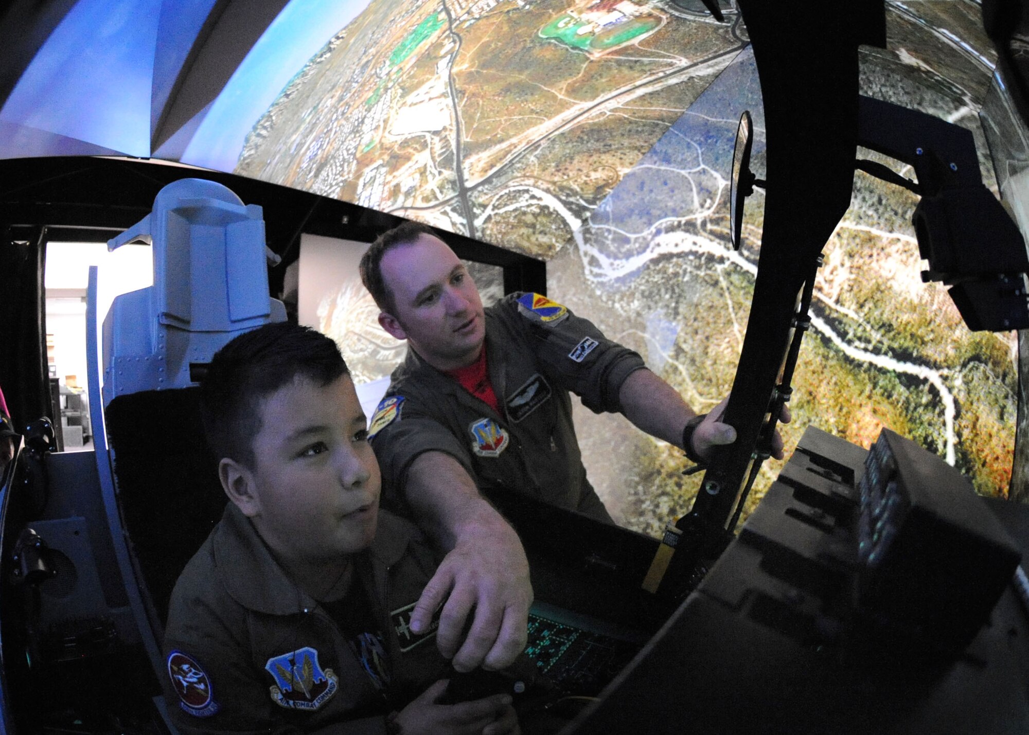 Pilot for a Day participant Marcus Lucero, seven years old, experiences flight in an A-10 simulator at the 355th Operations Group here Feb. 19. Marcus and his family were provided with a tour of the base and visited the 358th Fighter Squadron, the air traffic control tower and the D-M Fire Department. This program affords children with disabilities or serious illnesses with a day devoted to them and their interest in aviation. (U.S. Air Force photo/Airman Jerilyn Quintanilla)